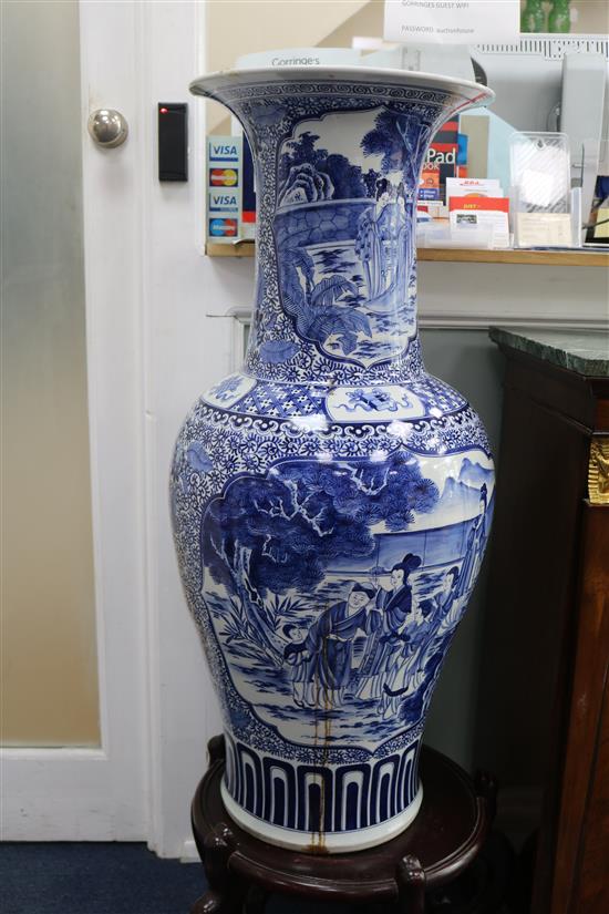 A massive Chinese blue and white vase and wood stand